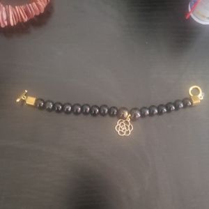 Black braclet with rose as the pendent
